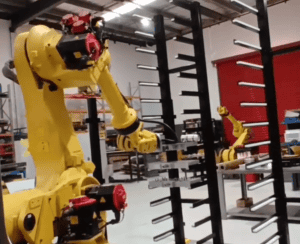 Lights out manufacturing Axistek - robot loading pallet racks for overnight machine tending